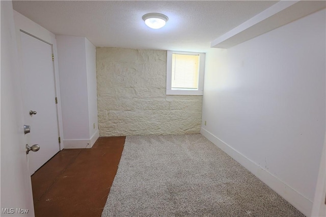 carpeted empty room with a textured ceiling