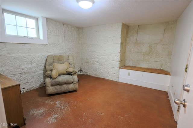 sitting room featuring concrete floors