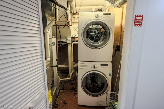 laundry area featuring stacked washing maching and dryer