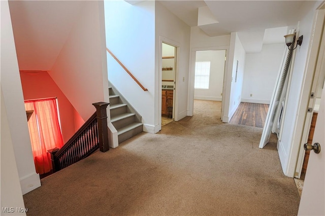 hallway featuring light carpet