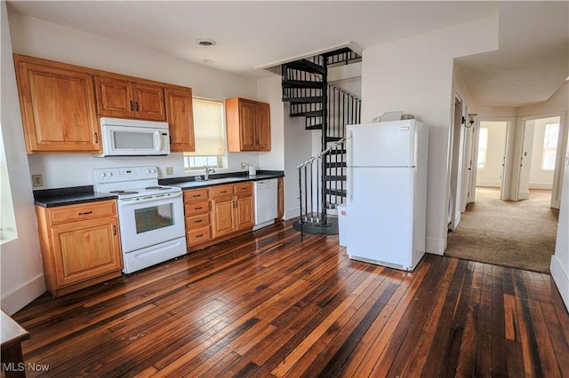 kitchen featuring sink, white appliances, and dark hardwood / wood-style floors