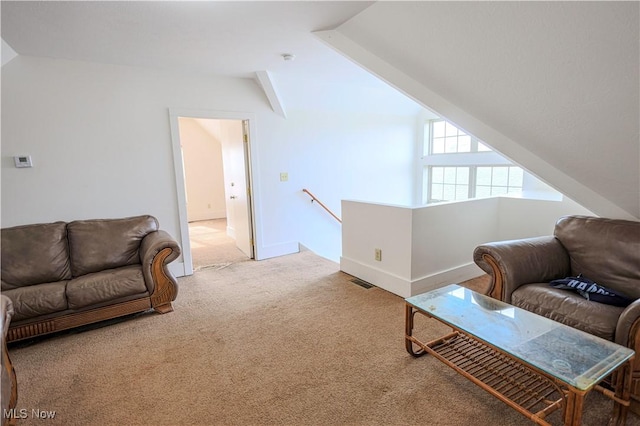 carpeted living room featuring vaulted ceiling