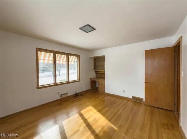 unfurnished living room with light wood-type flooring