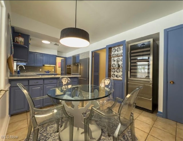 dining area with sink and light tile patterned flooring