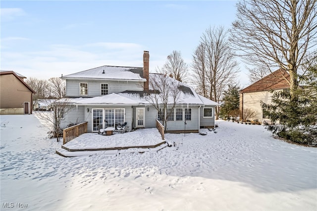 view of snow covered rear of property