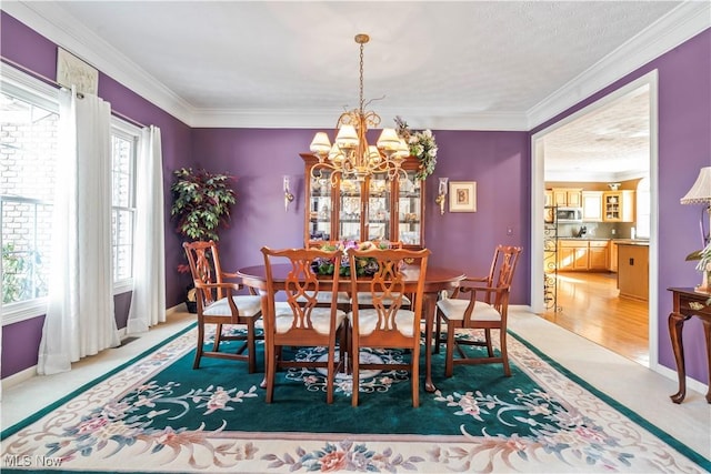 carpeted dining room featuring crown molding and a chandelier