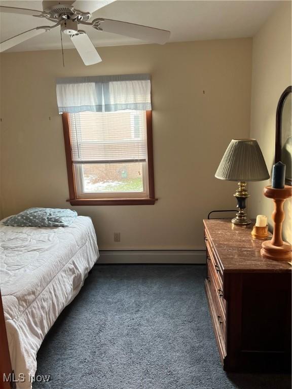 carpeted bedroom with baseboard heating and ceiling fan