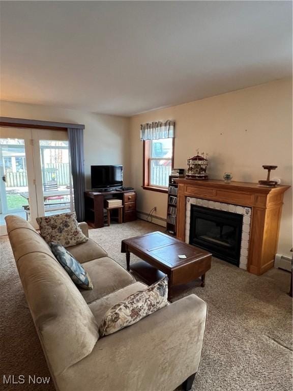 carpeted living room with a baseboard radiator and a fireplace