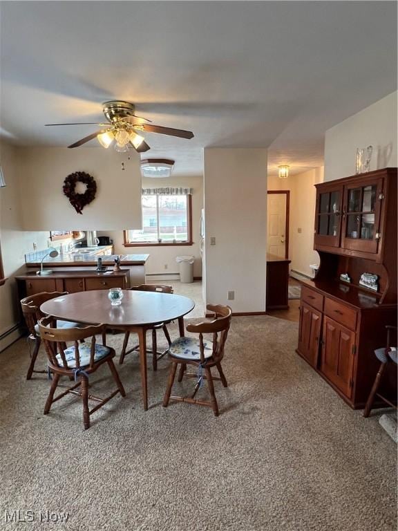 carpeted dining room featuring ceiling fan