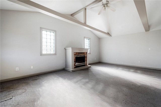 unfurnished living room with lofted ceiling with beams, a brick fireplace, and ceiling fan