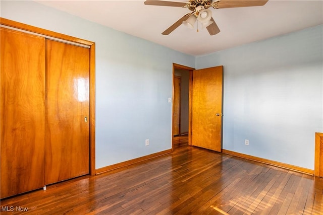 unfurnished bedroom with ceiling fan and dark hardwood / wood-style flooring