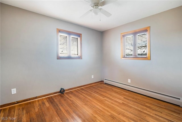 unfurnished room with a baseboard radiator, ceiling fan, and light wood-type flooring