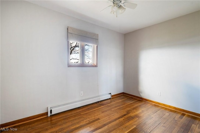 unfurnished room with a baseboard heating unit, wood-type flooring, and ceiling fan