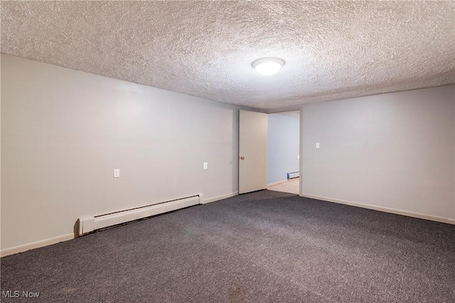 empty room featuring a baseboard radiator, carpet floors, and a textured ceiling