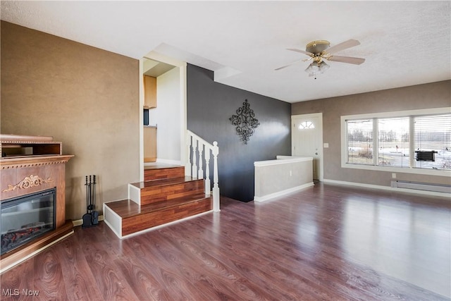 living room featuring wood-type flooring, a baseboard radiator, and ceiling fan