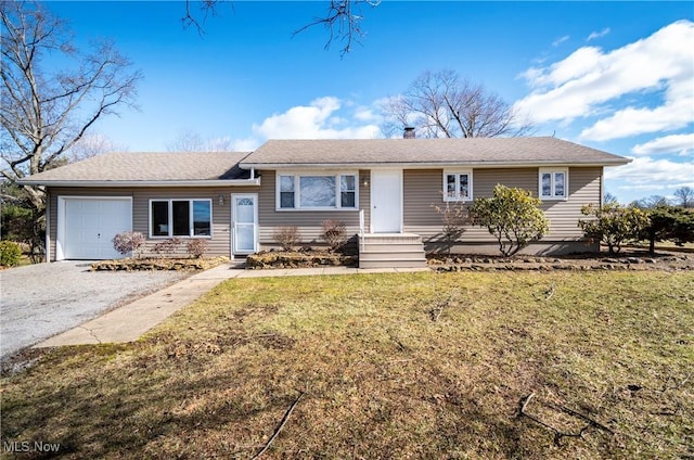 view of front of house with a garage and a front yard