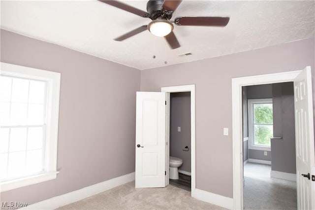 unfurnished bedroom with light carpet and ceiling fan