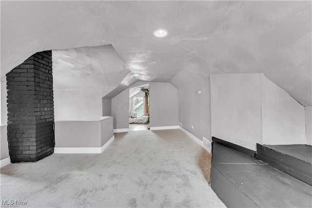 bonus room featuring lofted ceiling and carpet flooring