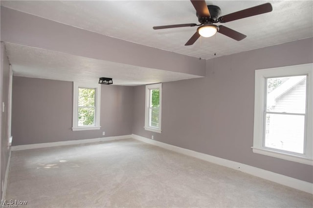 carpeted empty room with a textured ceiling