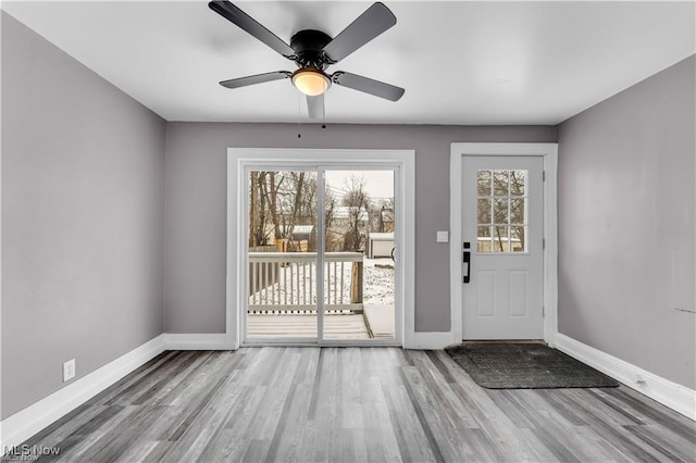 doorway to outside with ceiling fan and light hardwood / wood-style floors