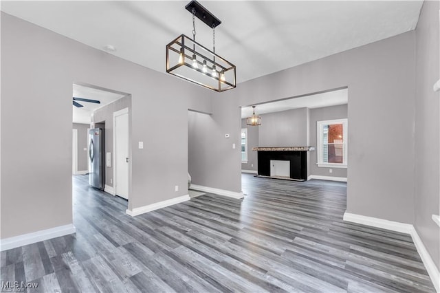 unfurnished living room with hardwood / wood-style flooring and ceiling fan