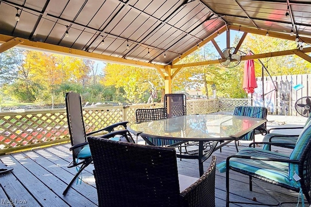 wooden deck with a gazebo and ceiling fan