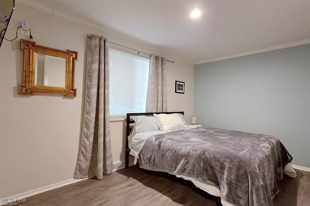 bedroom featuring crown molding and hardwood / wood-style flooring