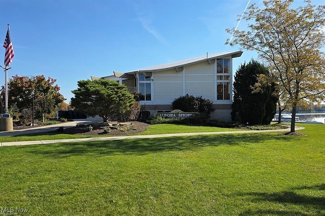 view of side of property featuring a water view and a yard