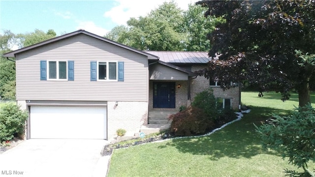 tri-level home featuring a garage and a front yard