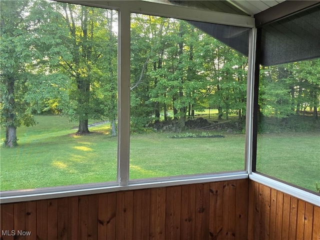 unfurnished sunroom featuring lofted ceiling