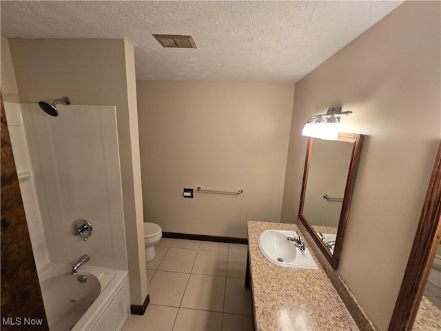 full bathroom with tub / shower combination, tile patterned flooring, vanity, a textured ceiling, and toilet