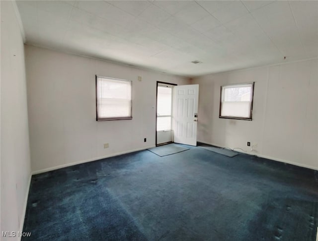 empty room with dark colored carpet