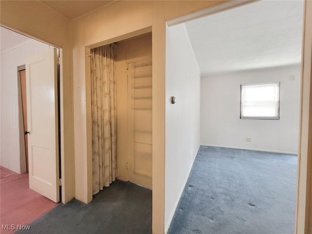 hallway with dark colored carpet