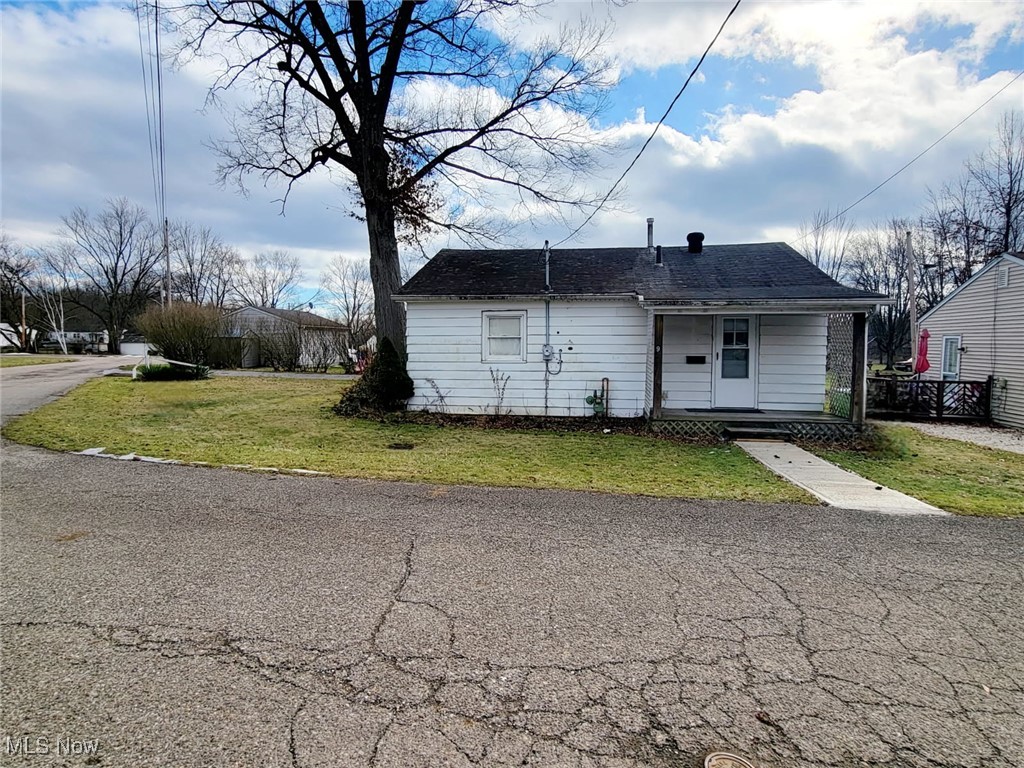 back of property with a porch and a yard