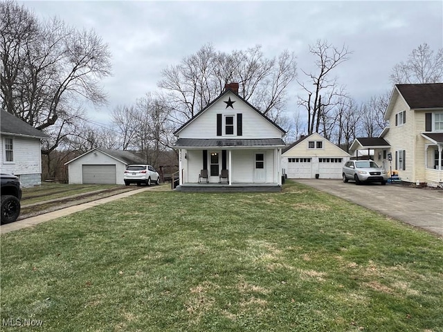 view of front of property featuring a garage, an outbuilding, covered porch, and a front lawn