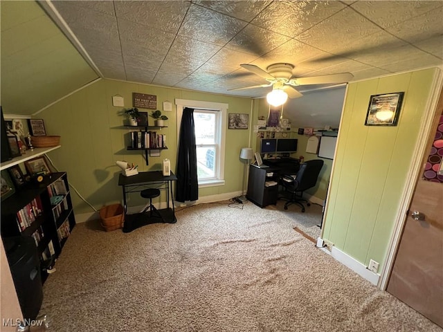 carpeted home office with lofted ceiling and ceiling fan