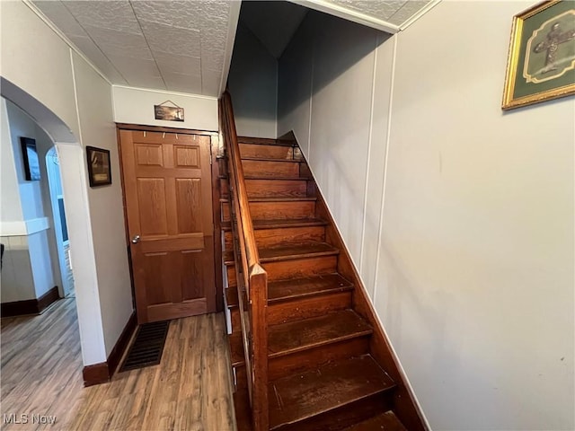 staircase featuring wood-type flooring