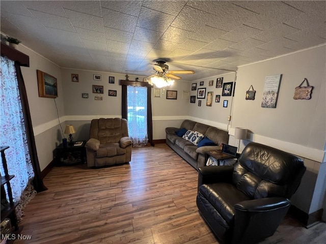 living room featuring ceiling fan and hardwood / wood-style floors