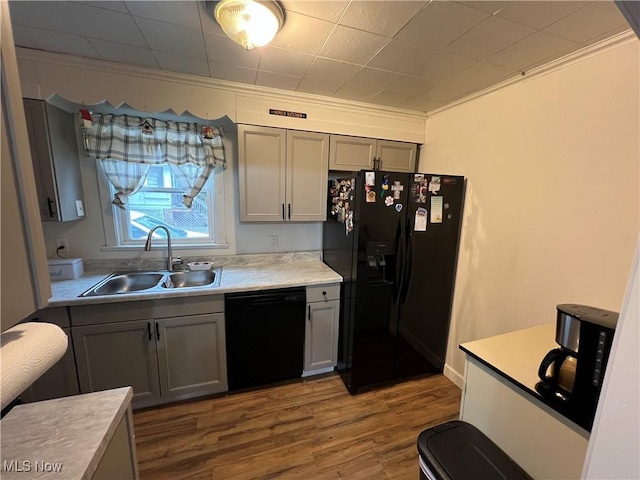 kitchen featuring crown molding, sink, gray cabinetry, and black appliances