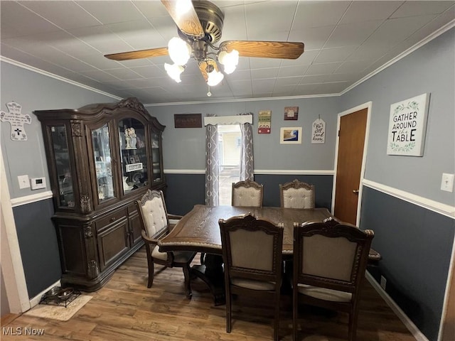 dining room featuring wood-type flooring, ornamental molding, and ceiling fan