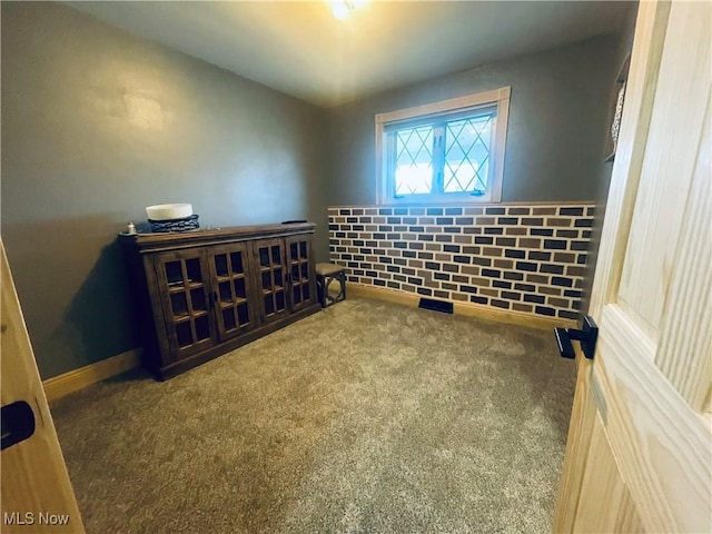 unfurnished room with carpet floors and baseboards