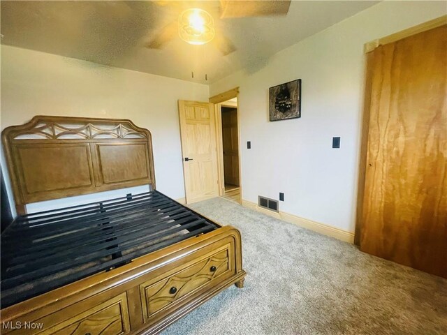 bedroom featuring light carpet and ceiling fan