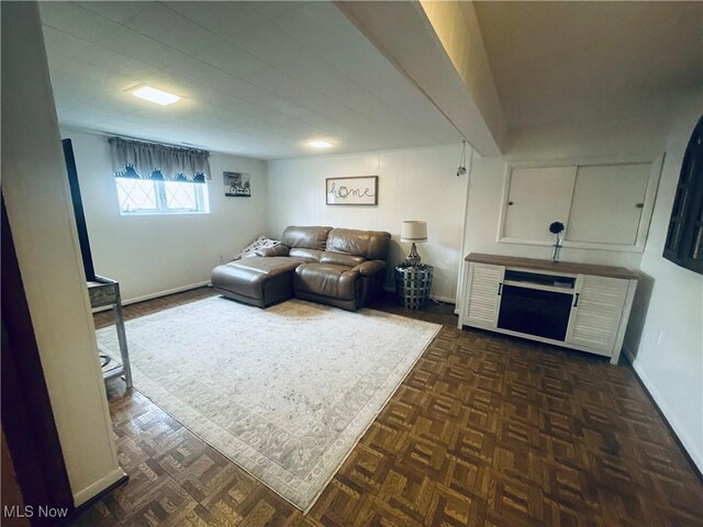 living room with a fireplace and dark parquet floors