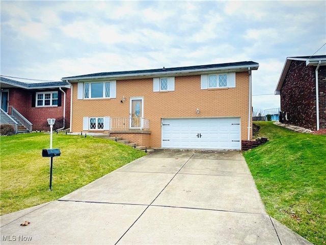 raised ranch with an attached garage, a front yard, concrete driveway, and brick siding