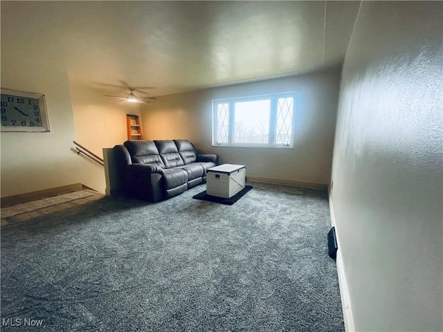 living area with carpet floors, a ceiling fan, and baseboards