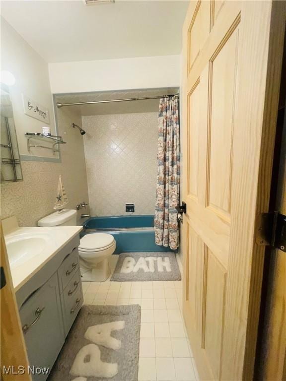 full bath with shower / bath combination with curtain, vanity, toilet, and tile patterned floors