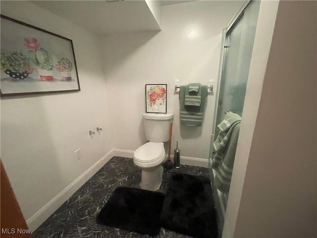 bathroom with walk in shower and toilet