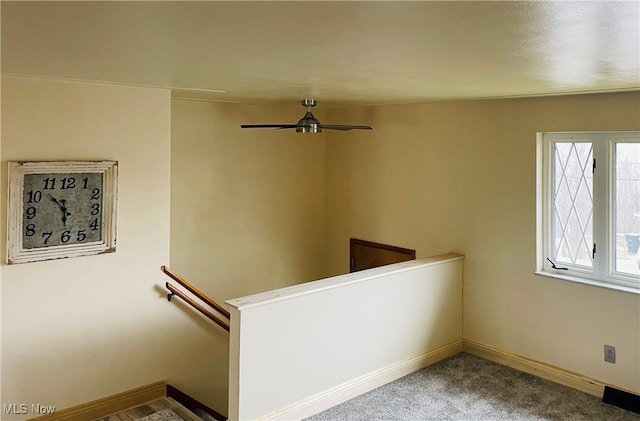 staircase with carpet floors, baseboards, and a ceiling fan