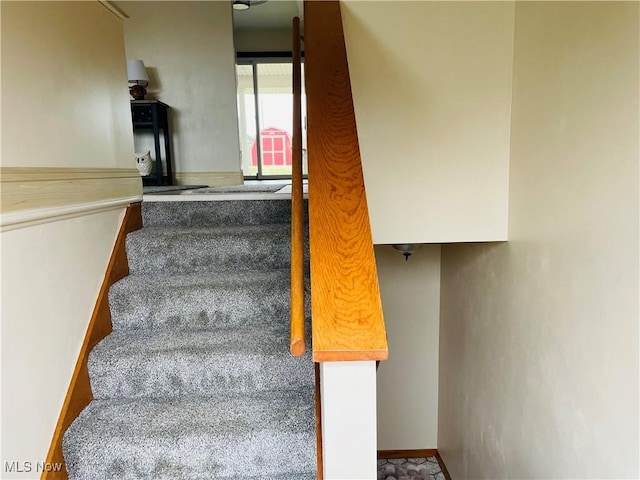 staircase featuring baseboards