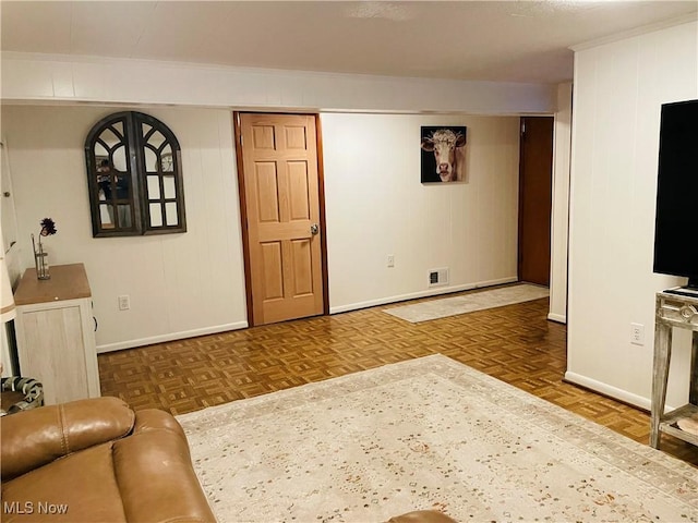 living area with parquet floors, baseboards, and visible vents